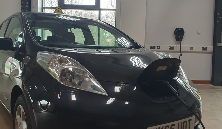 Photograph of Nissan Leaf plugged into electric charging point in Automotive Training Centre