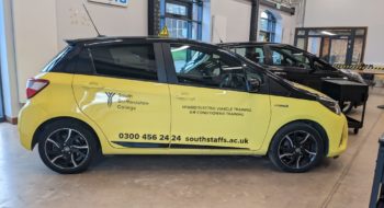 Yellow electric Toyota Yaris in Automotive Training Centre