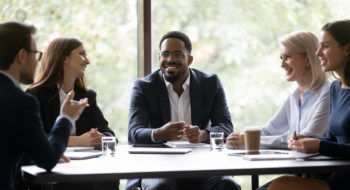 Group of business people chatting around a table
