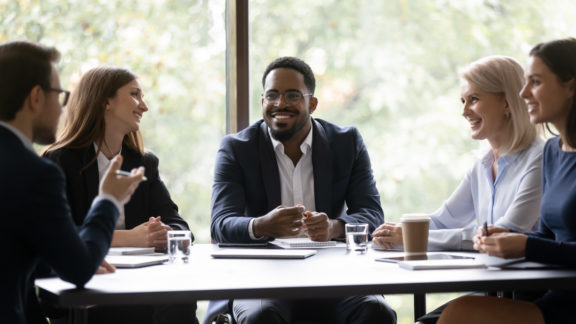 Group of business people chatting around a table