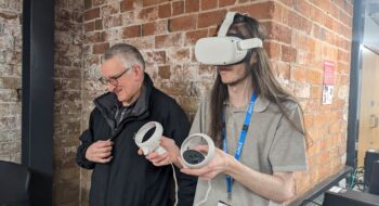 A member of staff and employer using VR headset