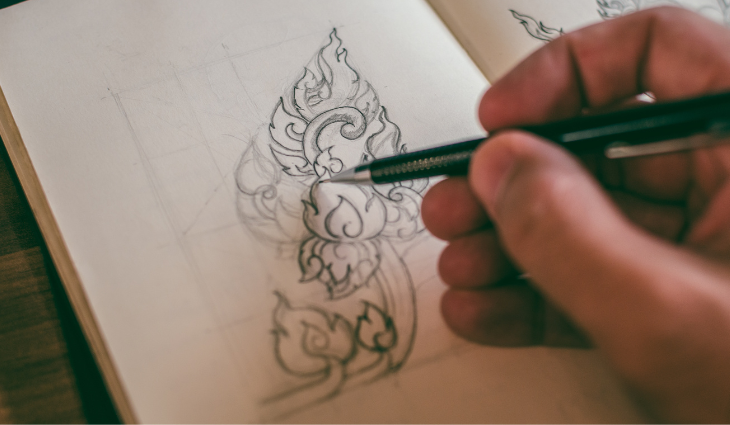 Person illustrating in sketchbook