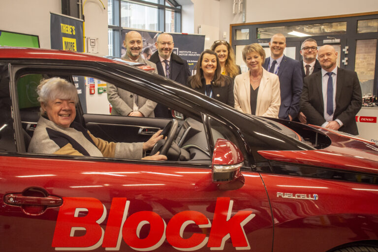 Cllr Kath Perry MBE sitting in hydrogen powered car