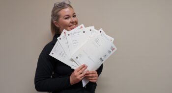 Issy holding lots of certificates